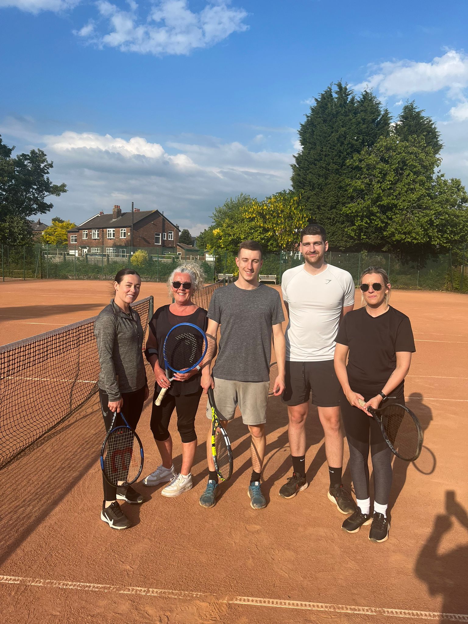 Claremont members enjoying tennis together on the clay courts