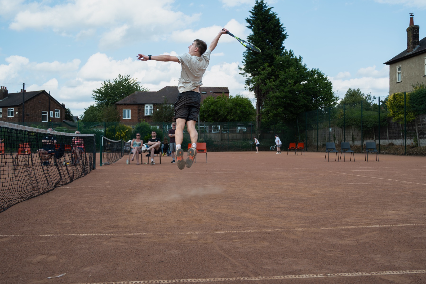 A Claremont player serving during tournament play