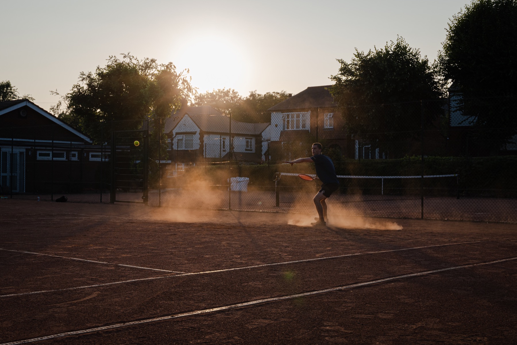 A player chasing a ball during sunset play at Claremont