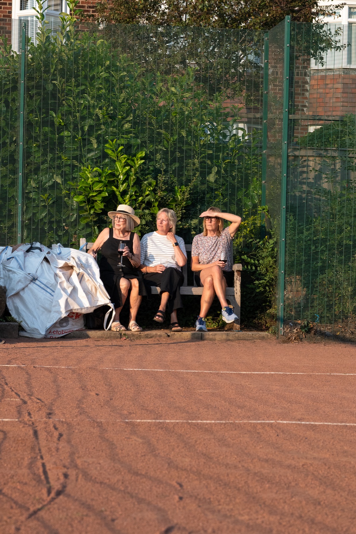 Members watching from the bench at Claremont