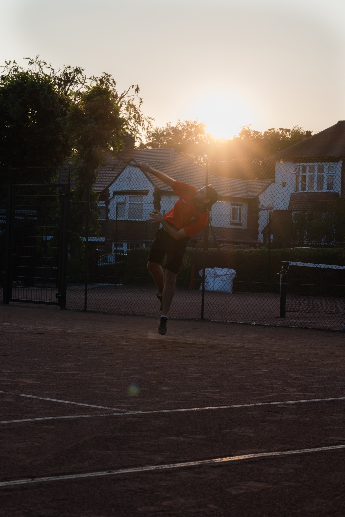 A player hitting a serve at Claremont